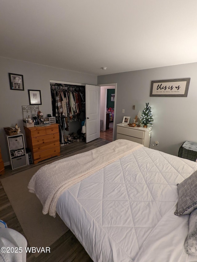 bedroom featuring a closet and dark wood-style flooring