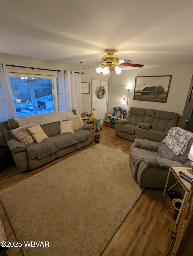 living room with ceiling fan and wood finished floors