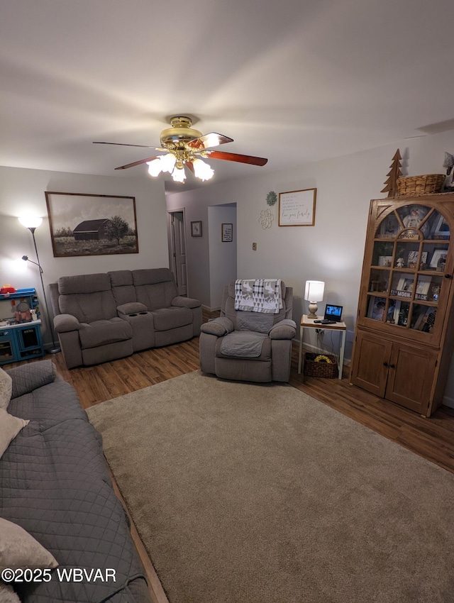 living room with a ceiling fan and wood finished floors