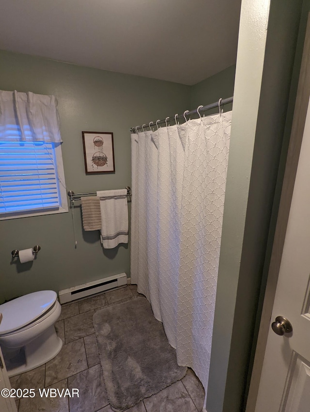 bathroom with toilet and baseboard heating