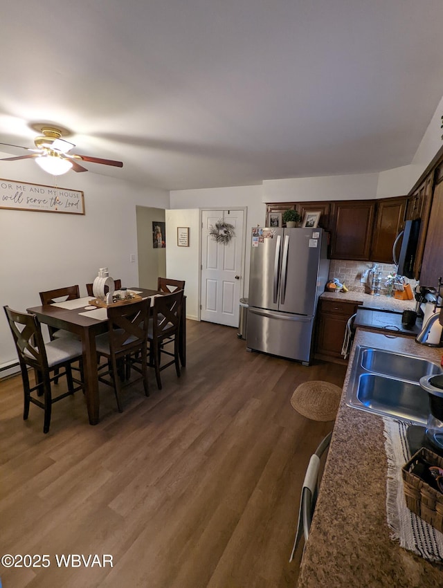 dining area with dark wood finished floors and a ceiling fan