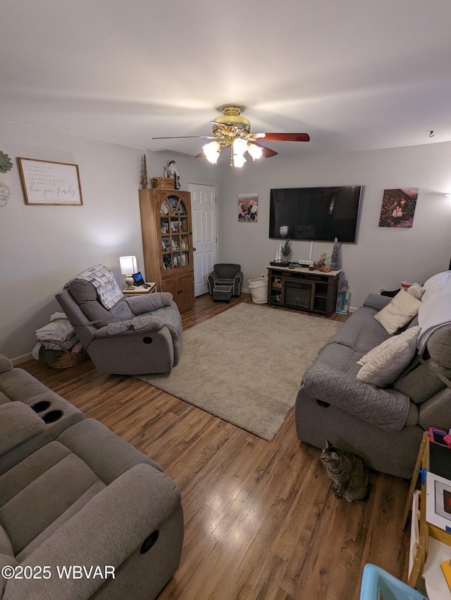 living room featuring ceiling fan and wood finished floors