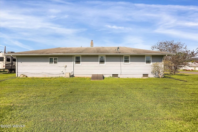 rear view of house featuring central AC and a yard