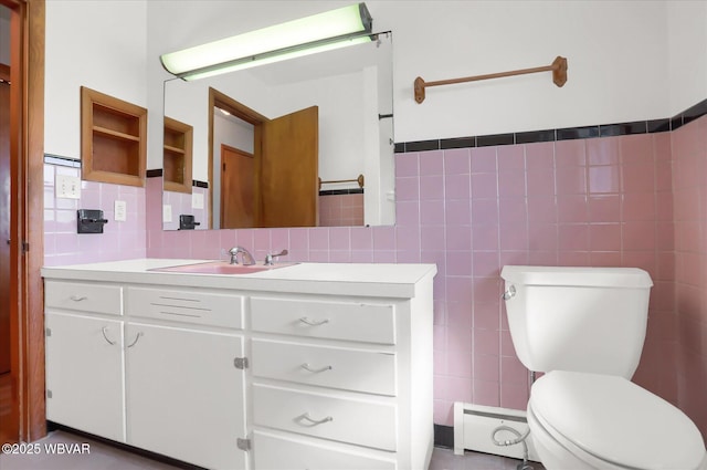 bathroom featuring vanity, tile walls, and toilet