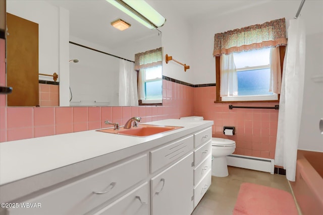 full bathroom with tile walls, a baseboard heating unit, vanity, shower / bath combination with curtain, and toilet