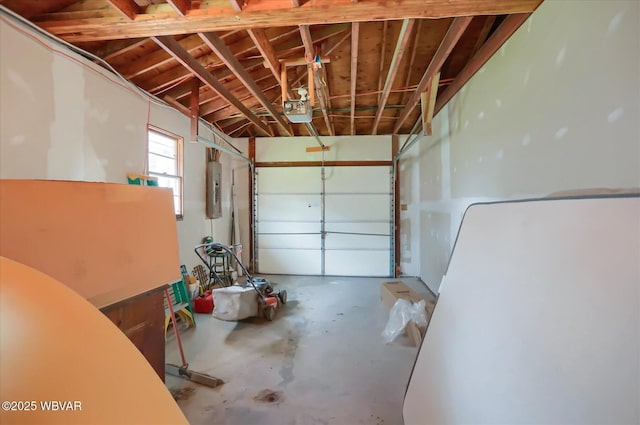 garage with a garage door opener and electric panel