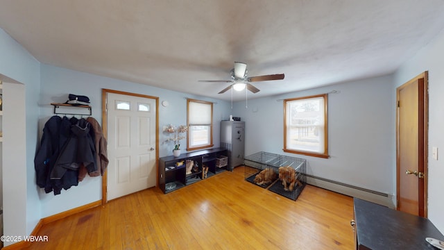 599 E Academy St, Hughesville, PA 17737 - interior space featuring a baseboard heating unit, plenty of natural light, ceiling fan, and hardwood / wood-style flooring