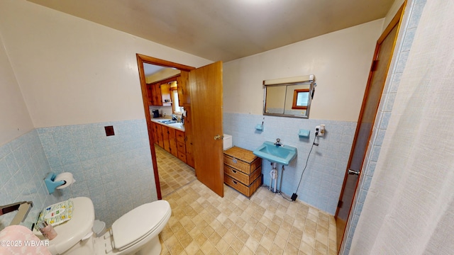 599 E Academy St, Hughesville, PA 17737 - full bath featuring toilet, a wainscoted wall, a sink, and tile walls