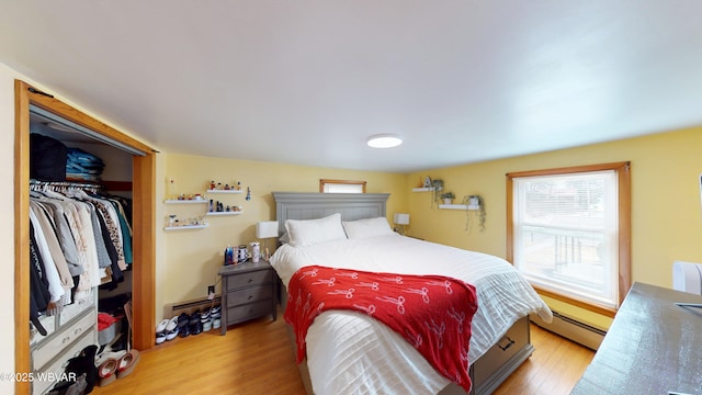 599 E Academy St, Hughesville, PA 17737 - bedroom featuring a baseboard heating unit, a closet, and light wood-style floors