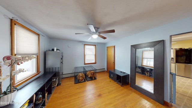 599 E Academy St, Hughesville, PA 17737 - interior space featuring ceiling fan, a baseboard radiator, light wood-type flooring, and freestanding refrigerator