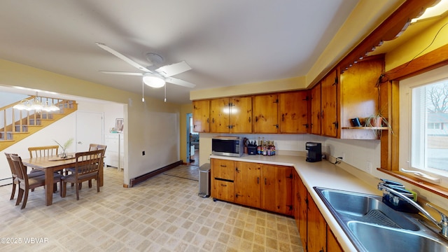 599 E Academy St, Hughesville, PA 17737 - kitchen featuring light countertops, stainless steel microwave, a sink, and brown cabinets