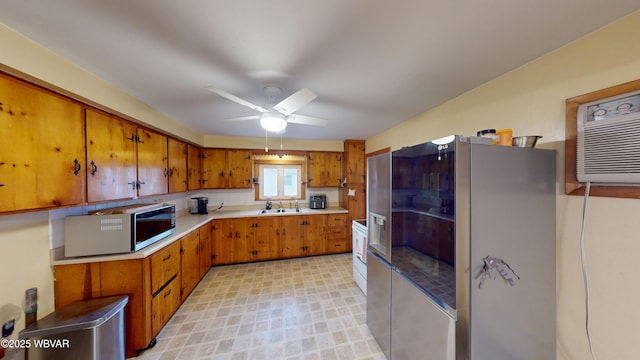 599 E Academy St, Hughesville, PA 17737 - kitchen featuring stainless steel appliances, light countertops, brown cabinetry, and a sink
