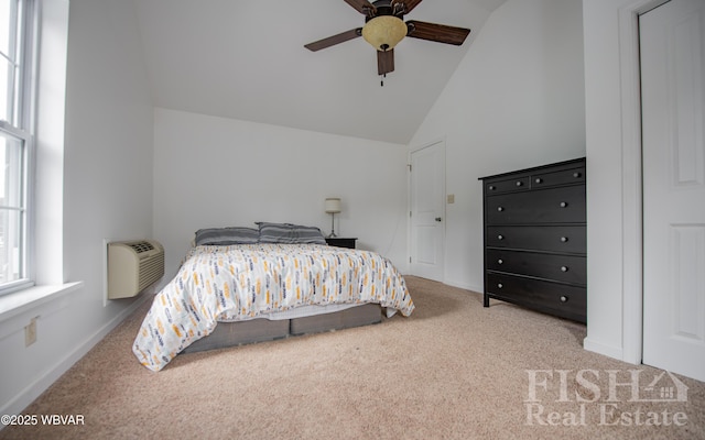 carpeted bedroom featuring high vaulted ceiling, ceiling fan, baseboards, and a wall mounted AC