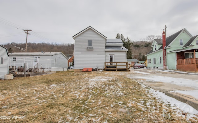 rear view of property featuring metal roof