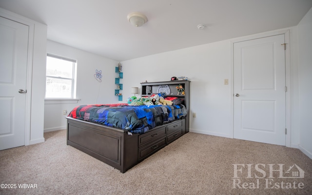 bedroom with light carpet and baseboards