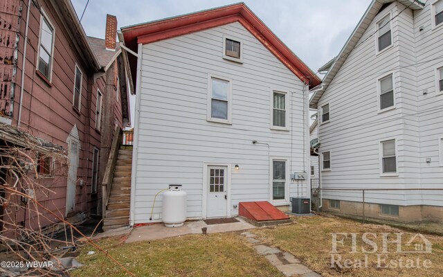 rear view of property with a yard