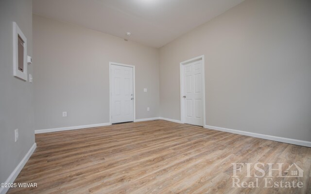 empty room with wood finished floors and baseboards