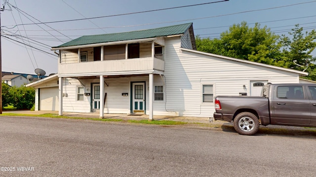 123 Broad St, Watsontown, PA 17777 - view of front of property with a balcony, a garage, and a metal roof