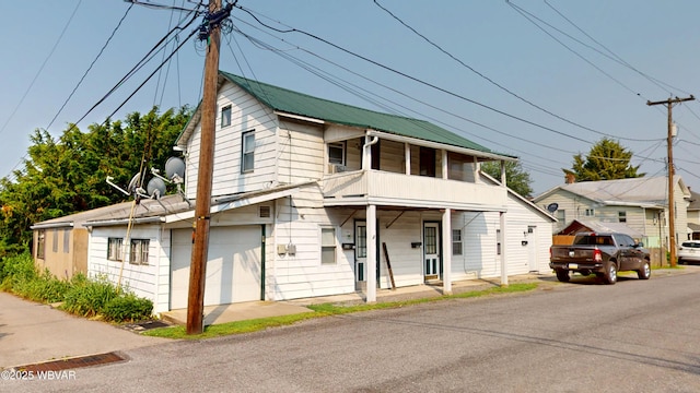 123 Broad St, Watsontown, PA 17777 - view of front facade with an attached garage and a metal roof