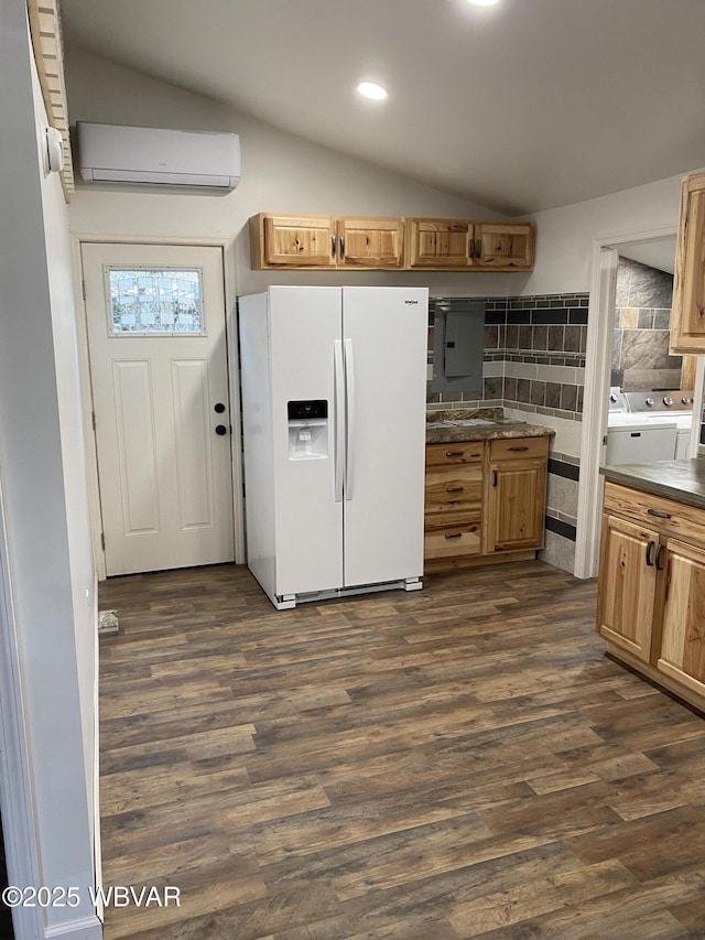 123 Broad St, Watsontown, PA 17777 - kitchen with white fridge with ice dispenser, a wall unit AC, washer and clothes dryer, vaulted ceiling, and dark wood-style floors