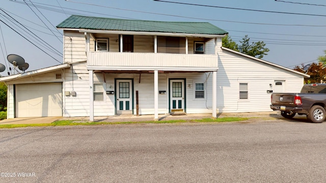 123 Broad St, Watsontown, PA 17777 - townhome / multi-family property featuring a balcony, a metal roof, and covered porch
