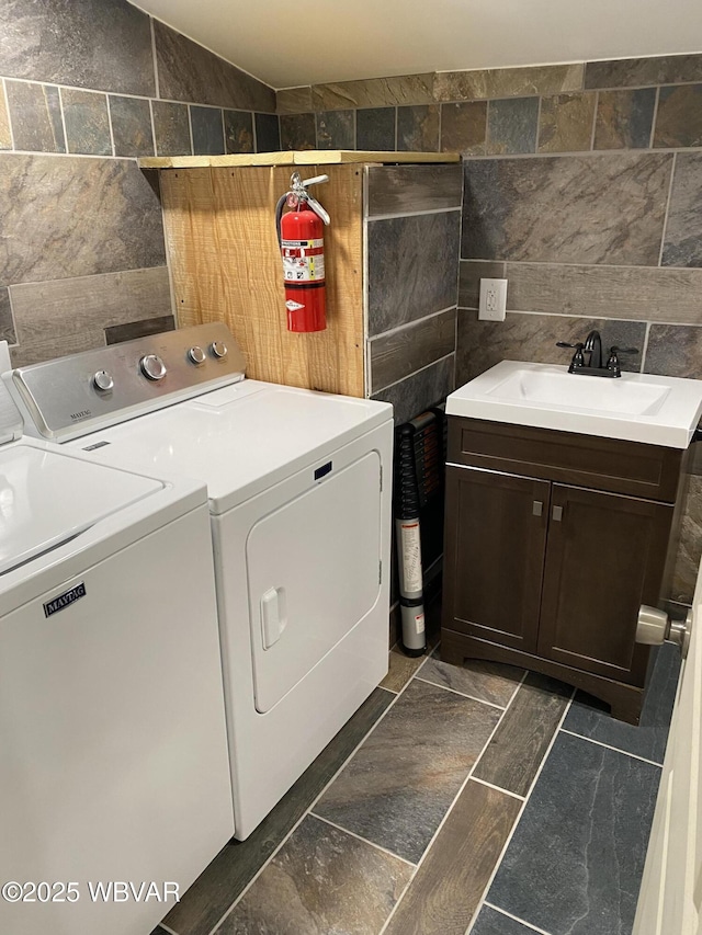 123 Broad St, Watsontown, PA 17777 - washroom featuring tile walls, washing machine and dryer, and cabinet space
