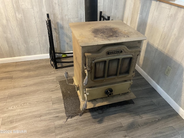 details featuring hardwood / wood-style flooring and a wood stove