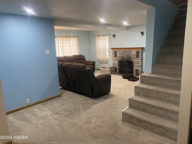 carpeted living room with a stone fireplace