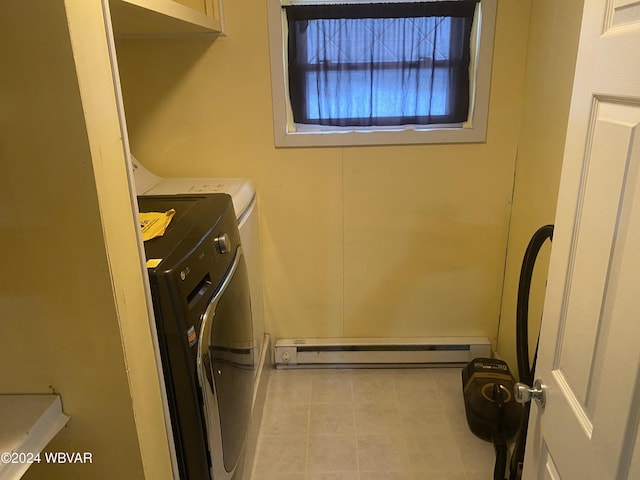 laundry area with separate washer and dryer and a baseboard heating unit