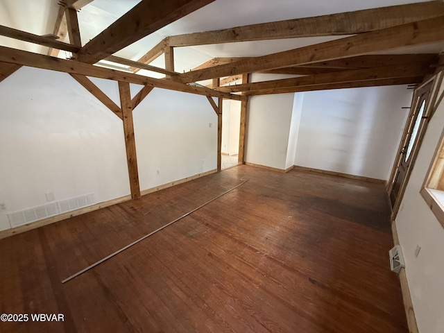 interior space featuring vaulted ceiling with beams and dark hardwood / wood-style flooring