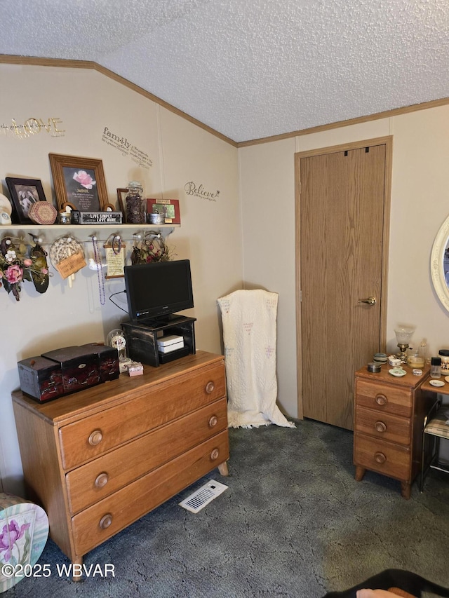 bedroom featuring dark colored carpet, lofted ceiling, crown molding, and a textured ceiling