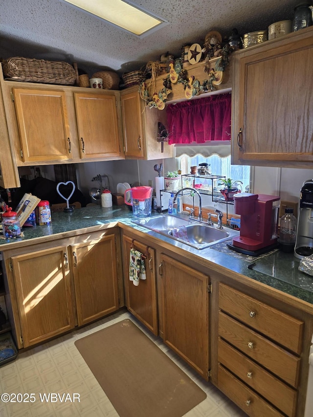 kitchen with sink and a textured ceiling