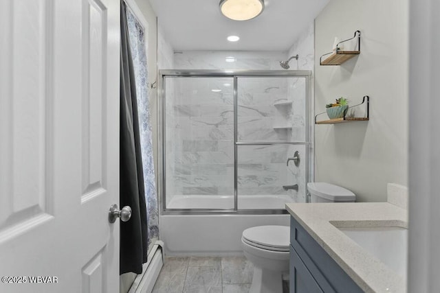 full bath featuring baseboard heating, toilet, bath / shower combo with glass door, and vanity