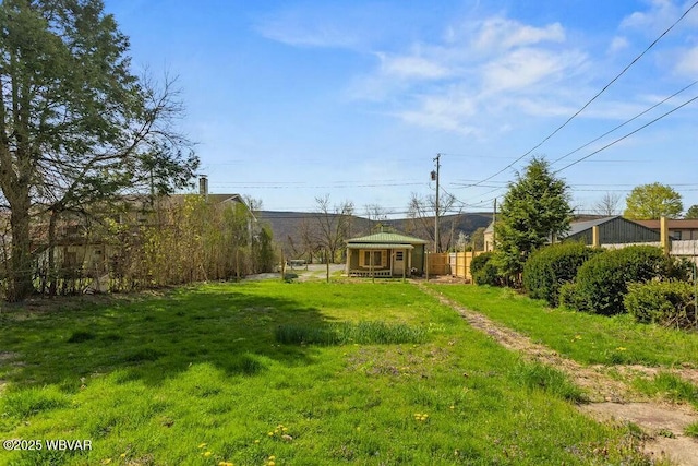 view of yard featuring an outbuilding and fence
