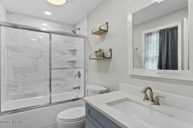 full bathroom featuring vanity, toilet, and enclosed tub / shower combo