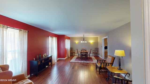 interior space featuring a wealth of natural light, dark wood-type flooring, and a notable chandelier