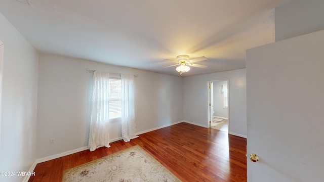 spare room featuring hardwood / wood-style floors and ceiling fan