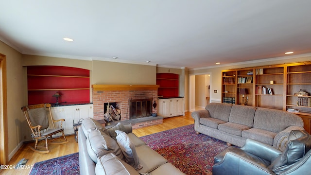 living room featuring a fireplace, ornamental molding, and hardwood / wood-style flooring