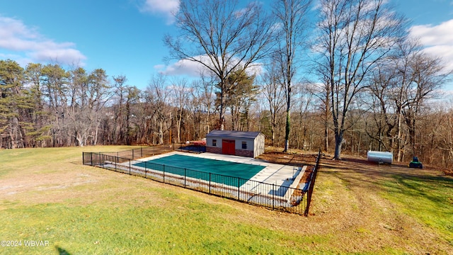 view of swimming pool featuring a yard and an outbuilding