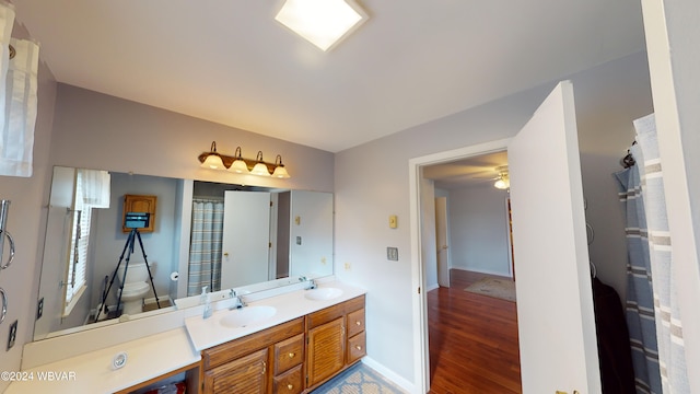 bathroom featuring hardwood / wood-style flooring, vanity, and toilet