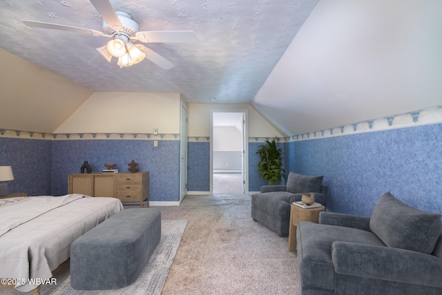 bedroom featuring ceiling fan, carpet floors, a textured ceiling, and lofted ceiling