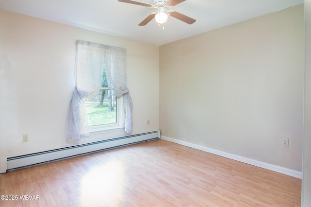 unfurnished room with baseboard heating, baseboards, wood finished floors, and ceiling fan