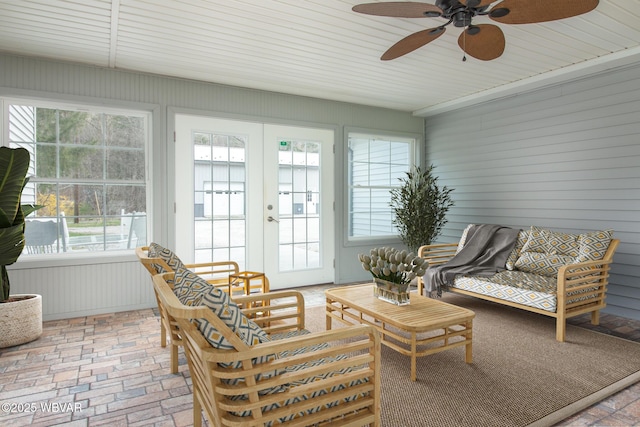 sunroom / solarium featuring french doors