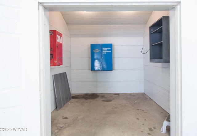 bathroom featuring lofted ceiling and concrete floors
