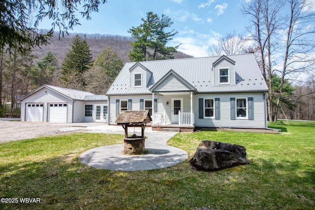 cape cod house featuring driveway, metal roof, an attached garage, and a front lawn