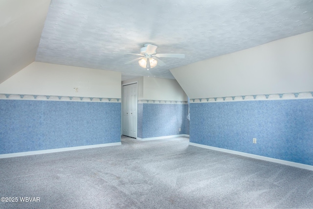 bonus room featuring baseboards, a ceiling fan, carpet, and vaulted ceiling