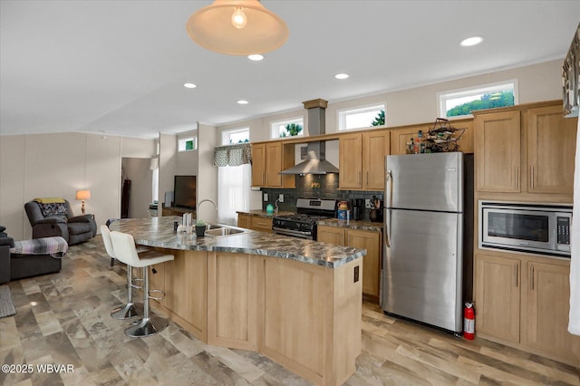 212 Sanctuary Blvd, Lock Haven, PA 17745 - kitchen featuring stainless steel appliances, wall chimney exhaust hood, open floor plan, an island with sink, and a kitchen breakfast bar