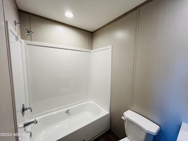 bathroom featuring shower / washtub combination and toilet