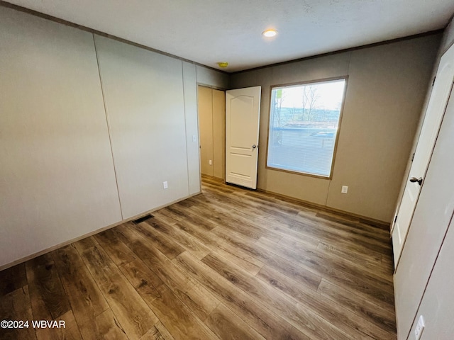 unfurnished bedroom with light wood-type flooring