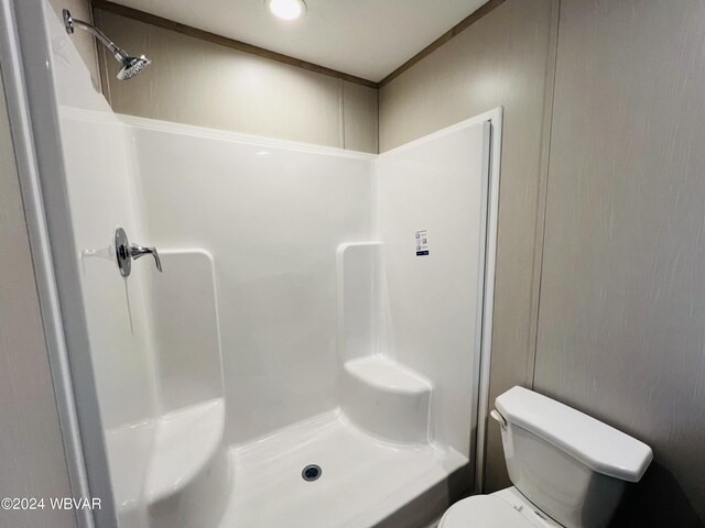 bathroom with toilet and walk in shower